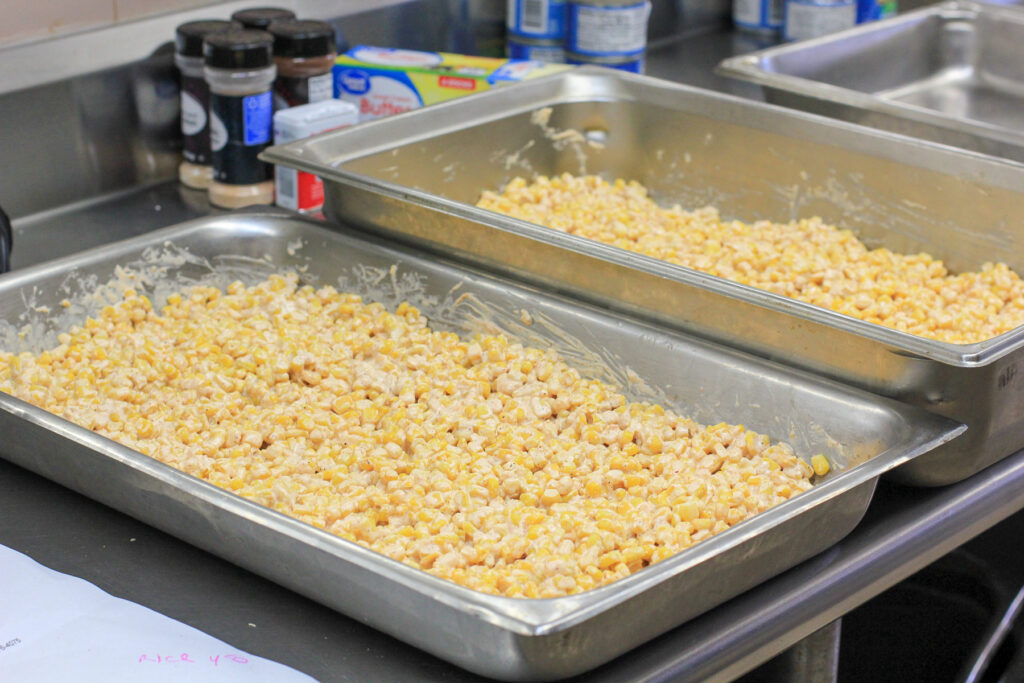 two hotels pans of assembled corn casserole before baking