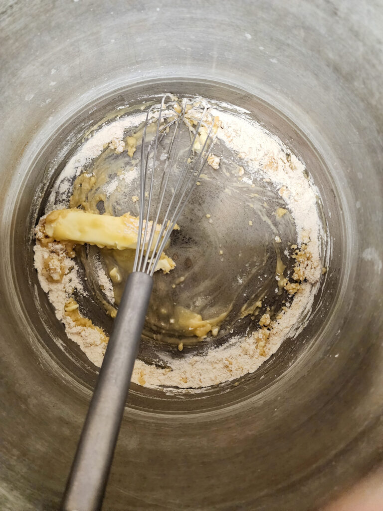 butter and flour in pot with whisk