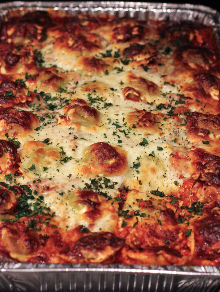prepared lasagna topped with herbs