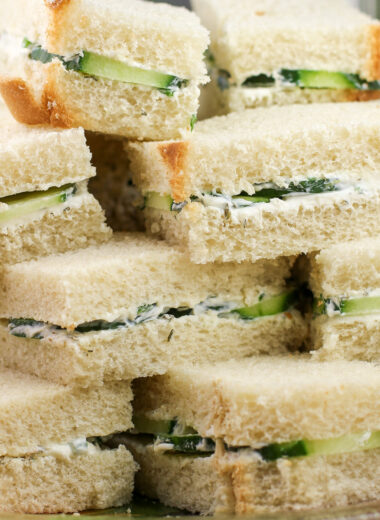 prepared English cucumber tea sandwiches stacked on a serving plate