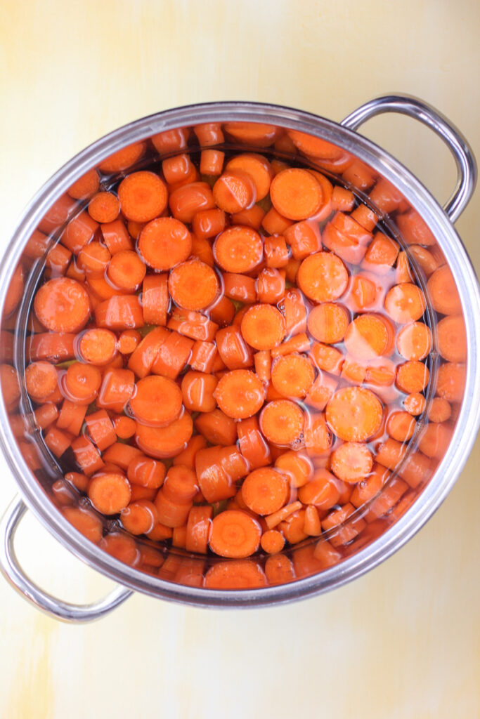 sliced carrots in large pot covered with juice