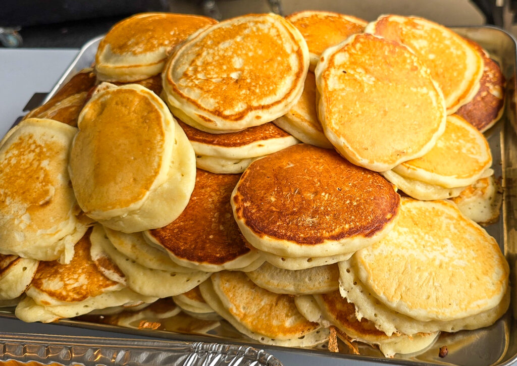 60 cooked pancakes stacked on tray