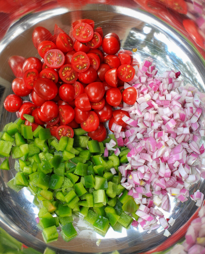 chopped tomatoes, onion, and green bell pepper in bowl