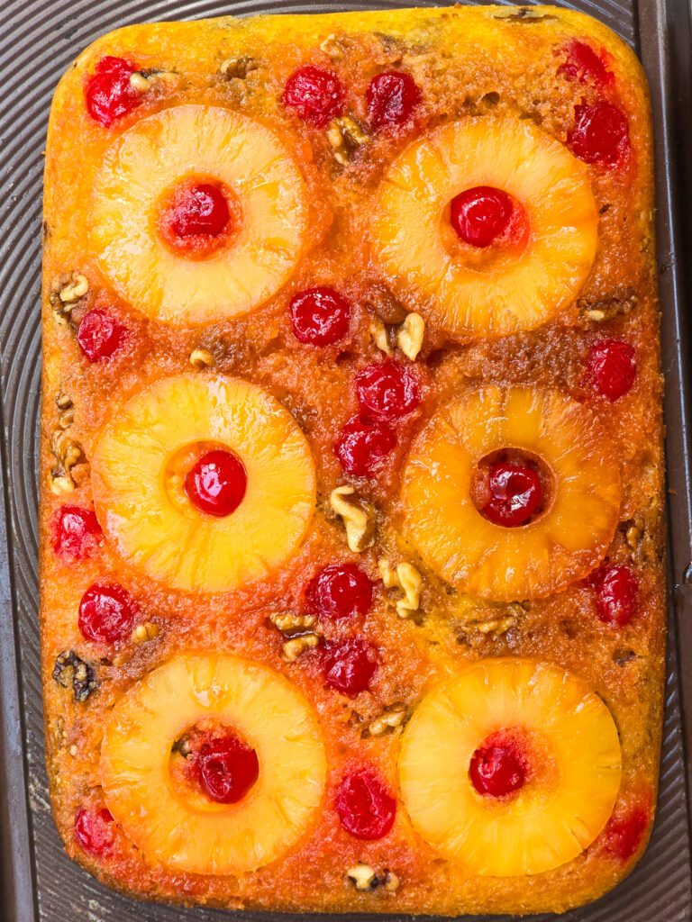 whole pineapple upside down cake, removed from bake dish, on bake dish