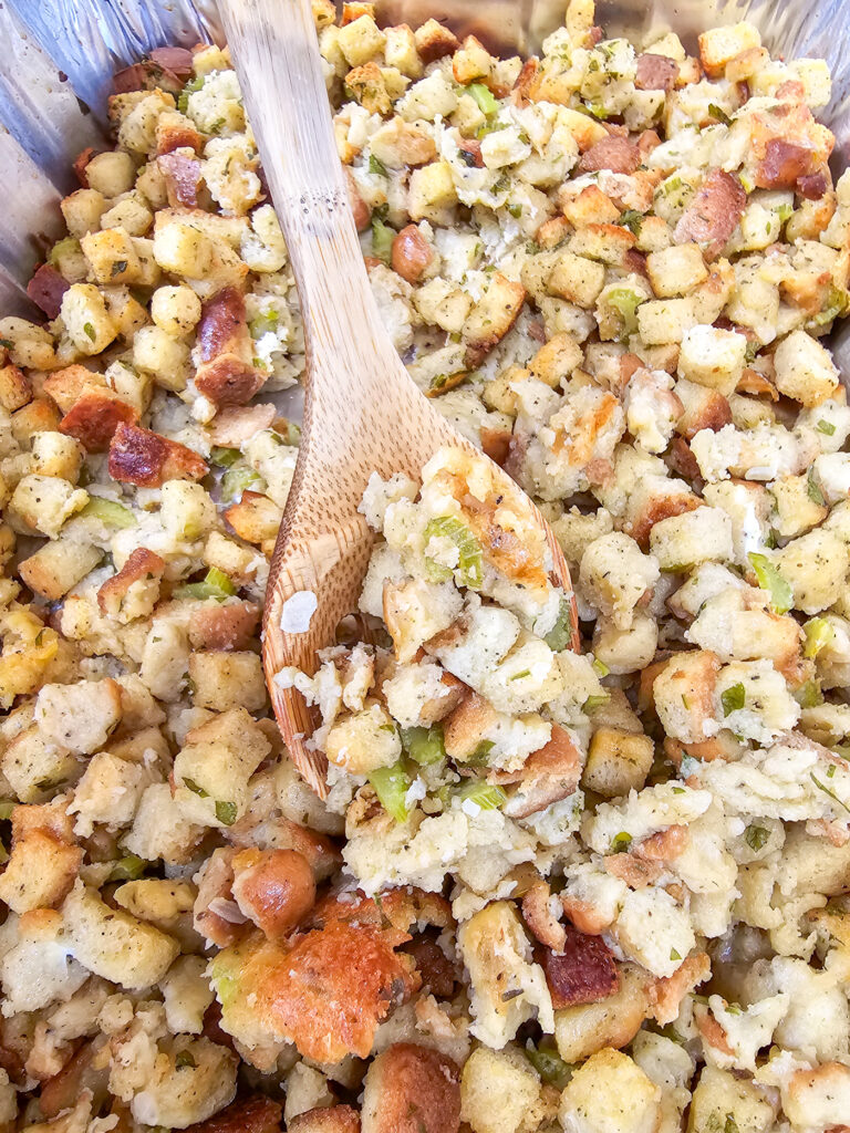 wood spoon inserted into cooked stuffing