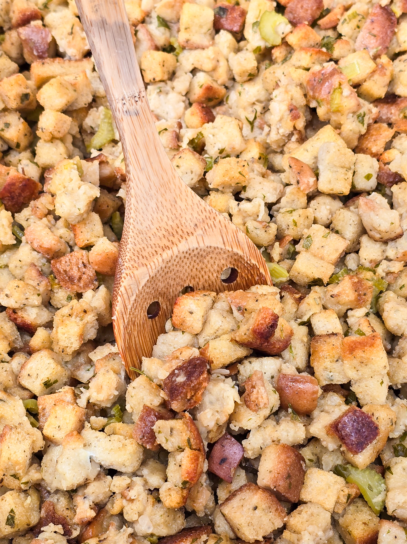 wood spoon inserted into cooked stuffing