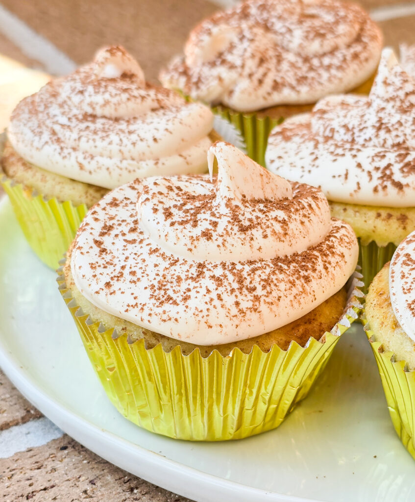 tiramisu cupcakes in gold foil on white plate