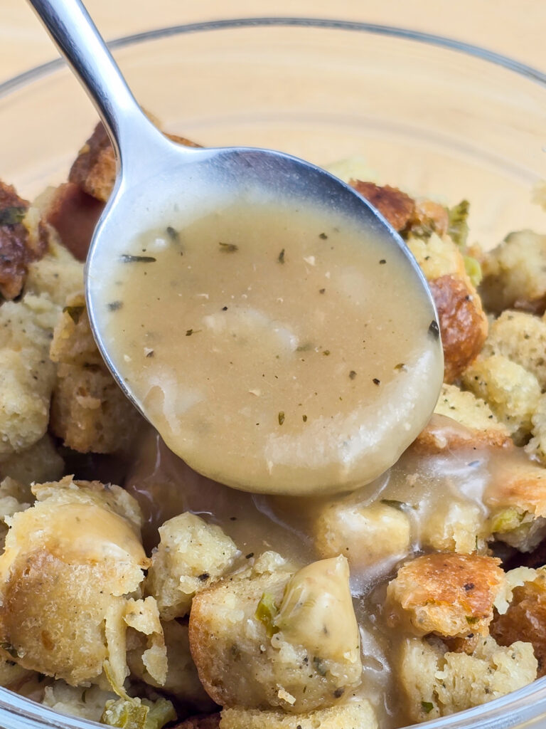 spoon putting gravy on stuffing